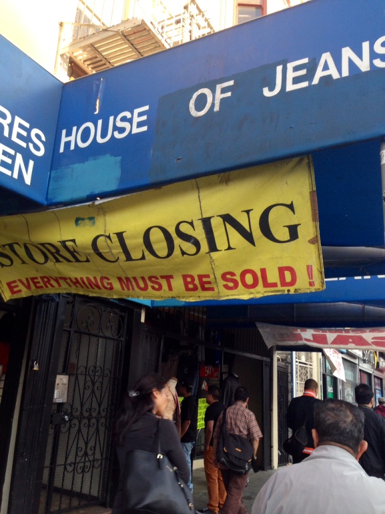 A banner announcing House of Jeans' closure near the entrance to the store on Mission Street
